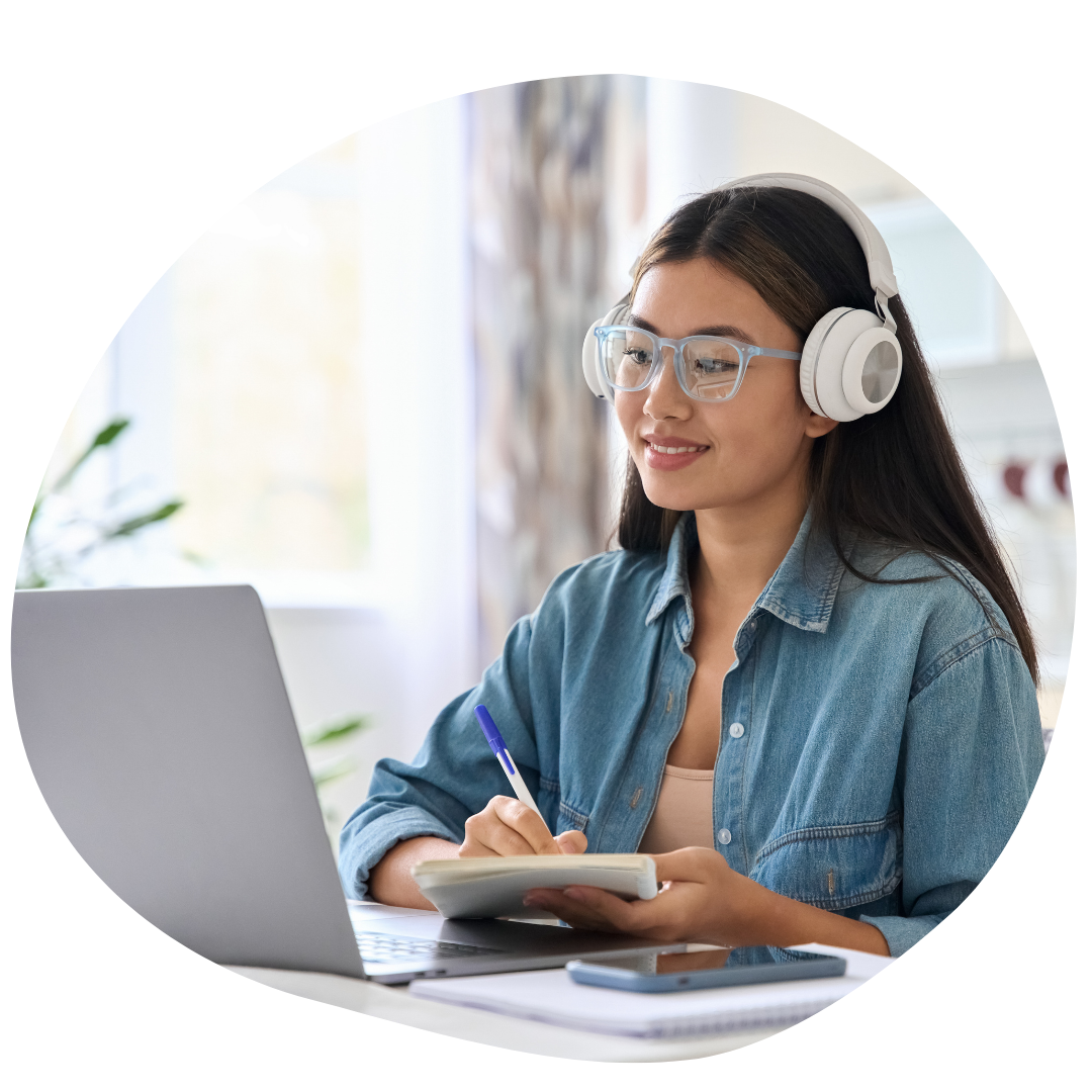 Female student on a Prepory webinar with headphones on and a note pad