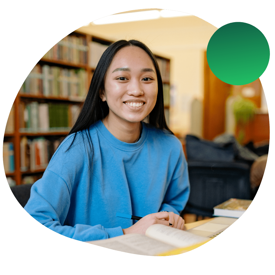 Student smiling at the library while working on her gap year internship applications