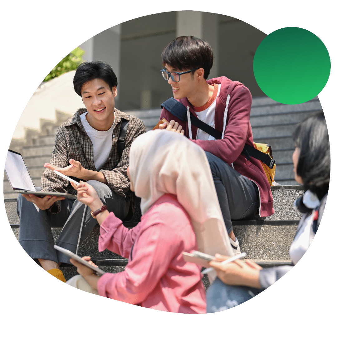 UC Irvine students sitting and talking on the steps of a building