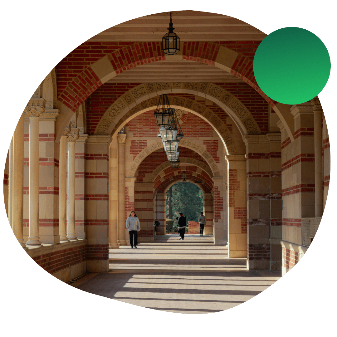 UCLA students walking down the arched corridors on campus