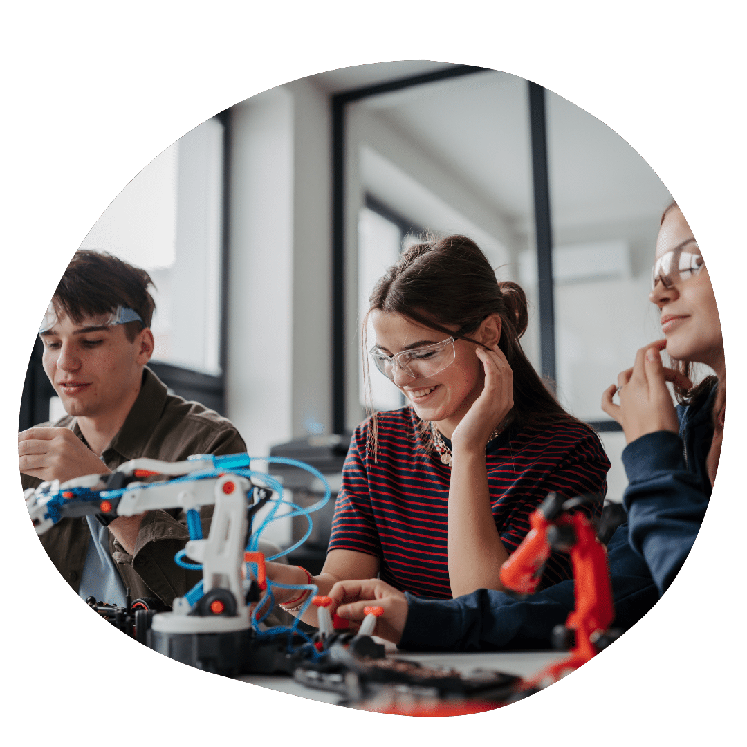 High school student building a robot at a STEM extracurricular club