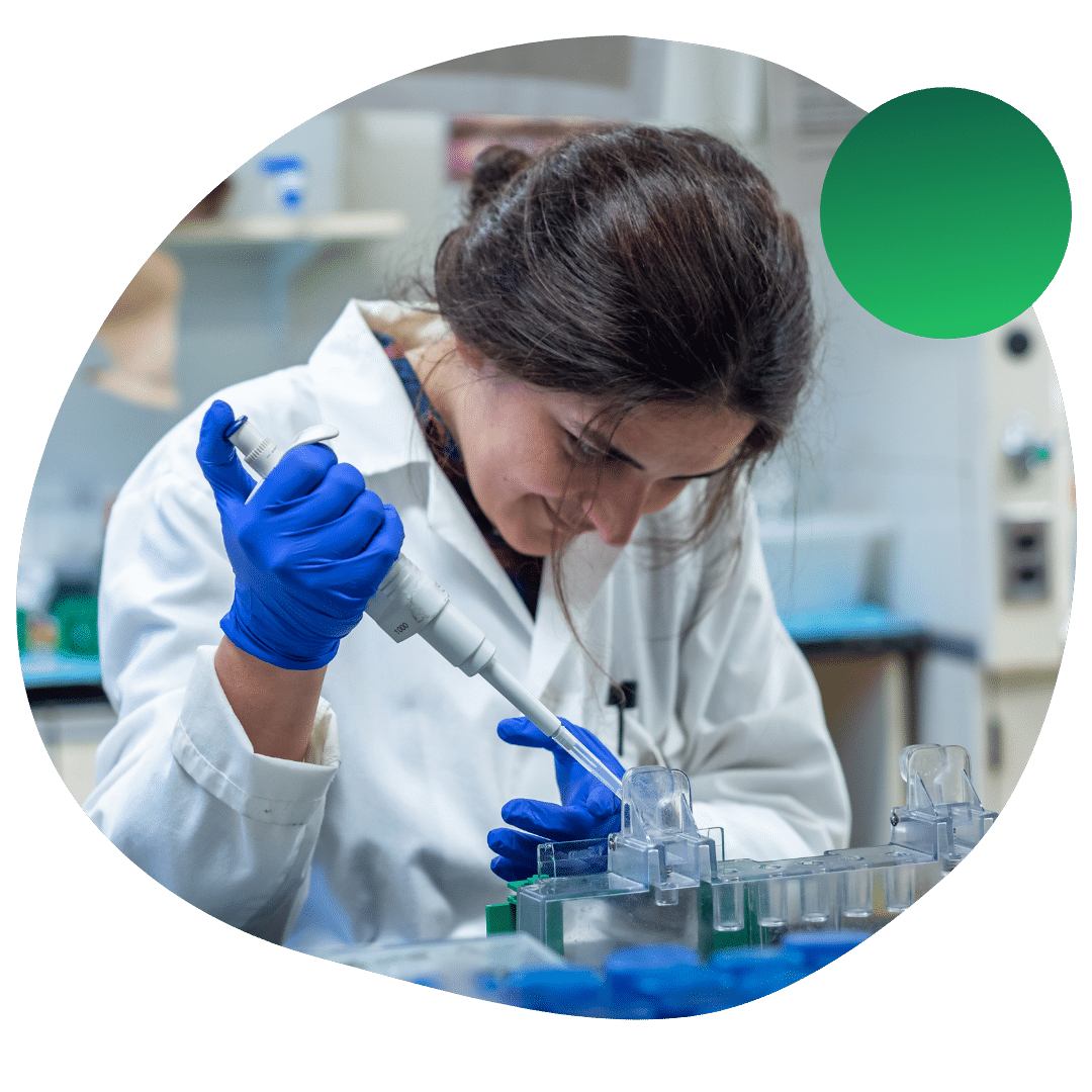 A Master's student carefully working in a lab