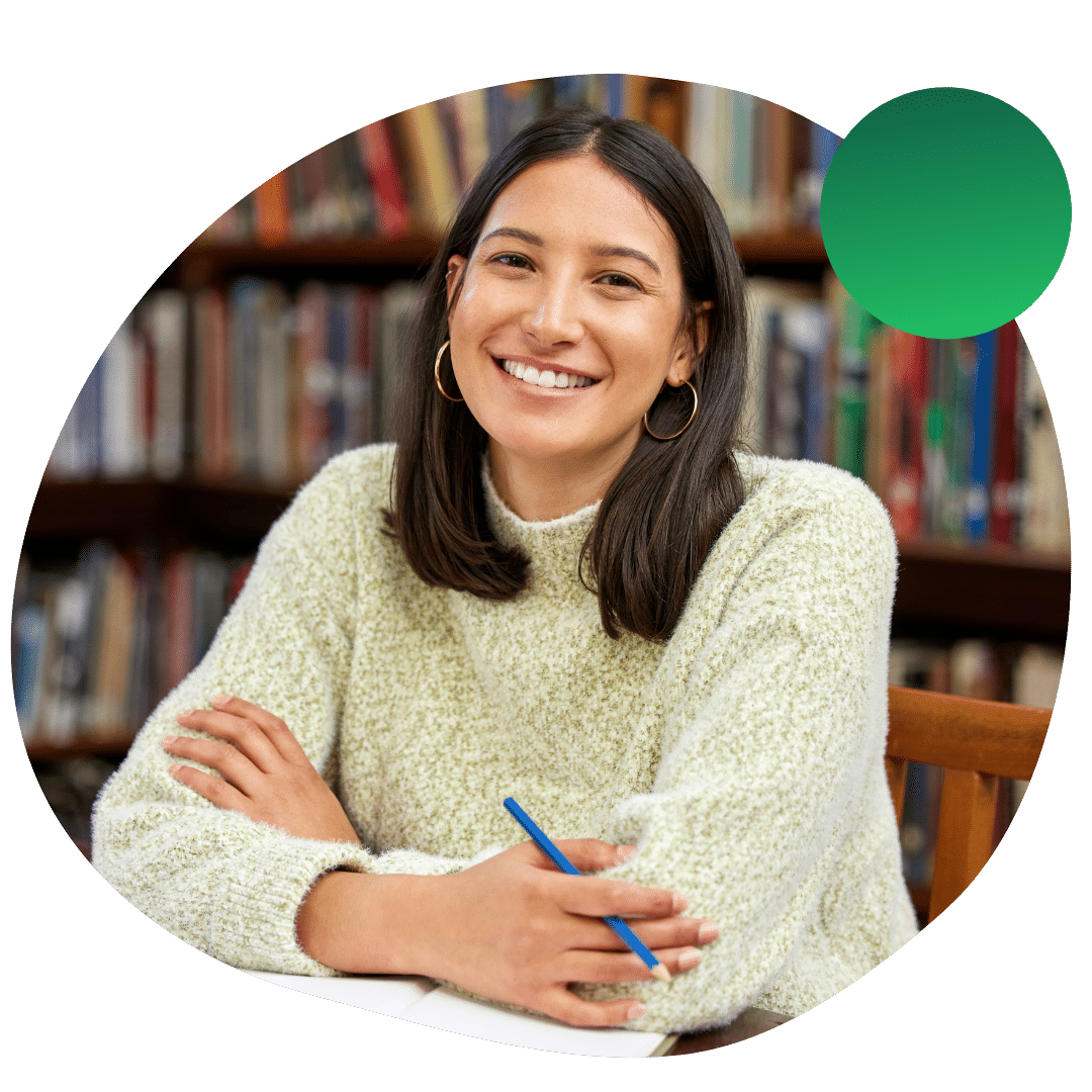 Student smiling while studying in the library
